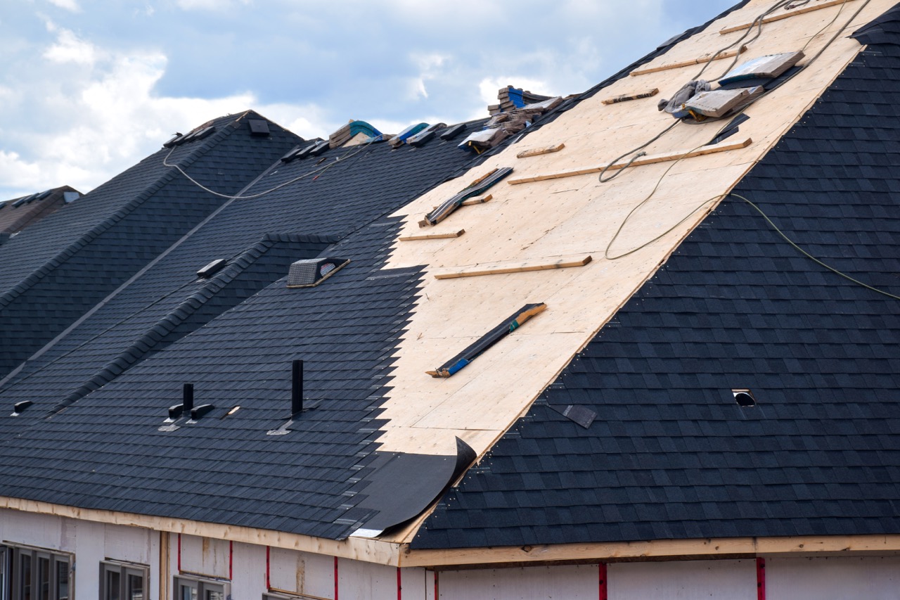 Roof system in mid-replacement showing exposed deck and new layer being installed — same step-by-step diligence we apply to flat-roof system swaps.